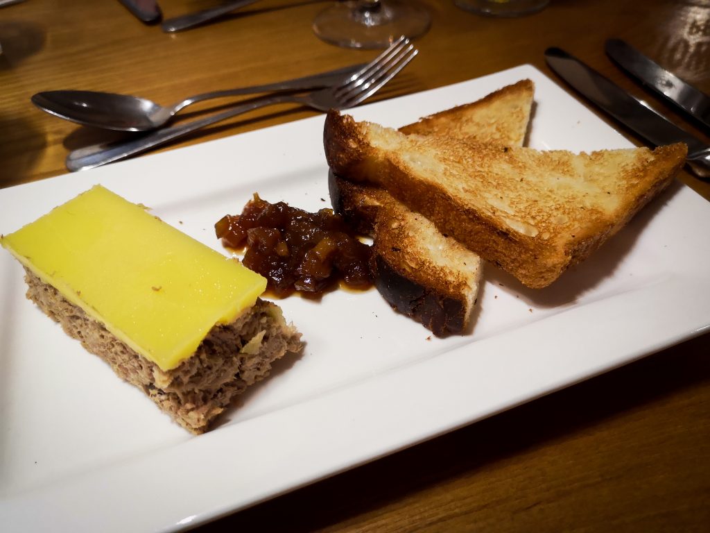 Rabbit rillette pate served with apricot chutney and brioche toast
