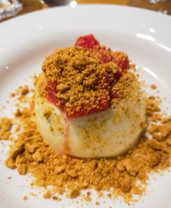 Creamy vanilla pannacotta with forced rhubarb and ginger nut crumb